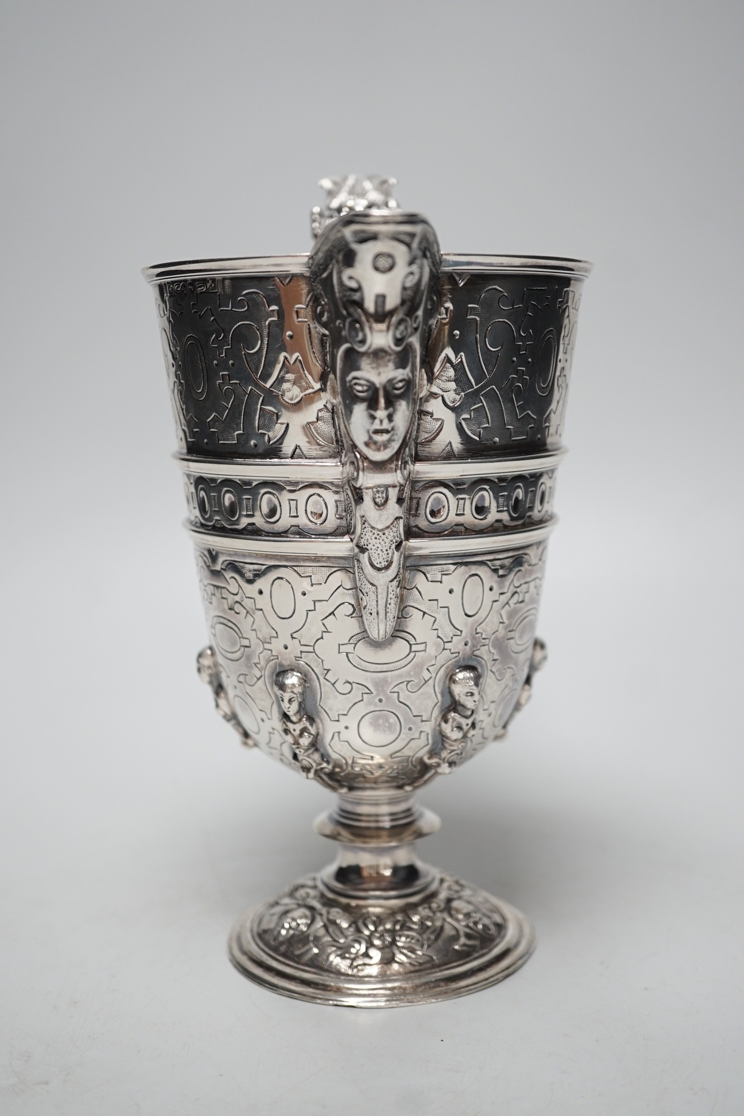 A mid 20th century Spanish? white metal ewer, with engraved, caryatid and mask decoration, height 22.2cm, 26.7oz.